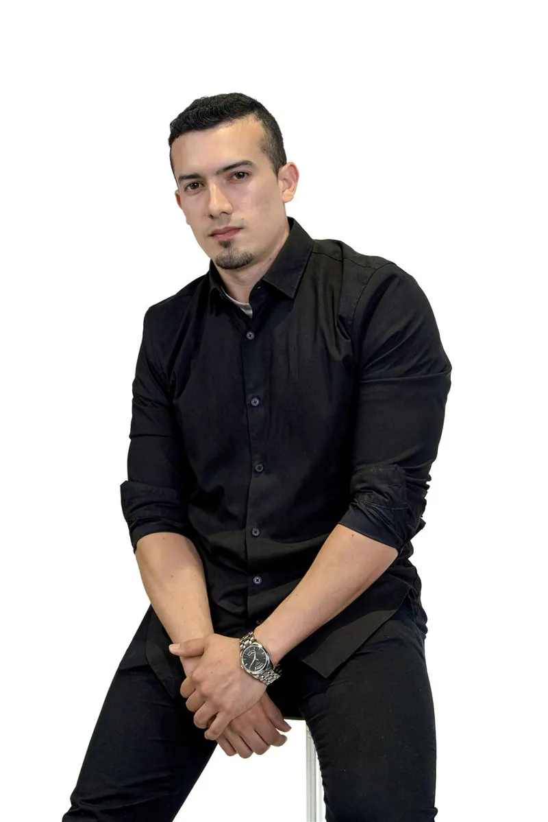 Eduardo Rincón seated in a black button-up shirt — brand photography session in Orlando